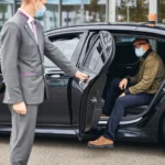 man-eyeglasses-getting-out-elite-taxi