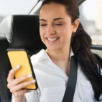 passenger-using-her-mobile-phone-car